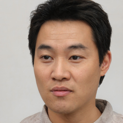 Neutral asian adult male with short  black hair and brown eyes