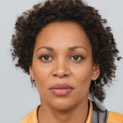 Joyful black adult female with short  brown hair and brown eyes