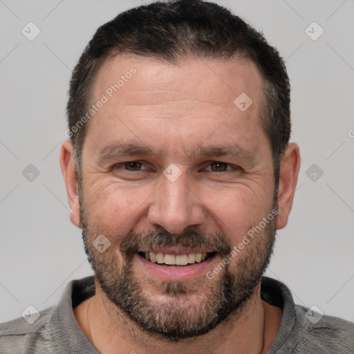 Joyful white adult male with short  brown hair and brown eyes