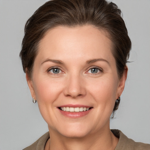 Joyful white adult female with short  brown hair and grey eyes