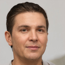 Joyful white adult male with short  brown hair and brown eyes