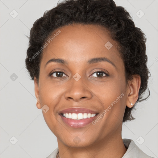 Joyful black young-adult female with short  brown hair and brown eyes