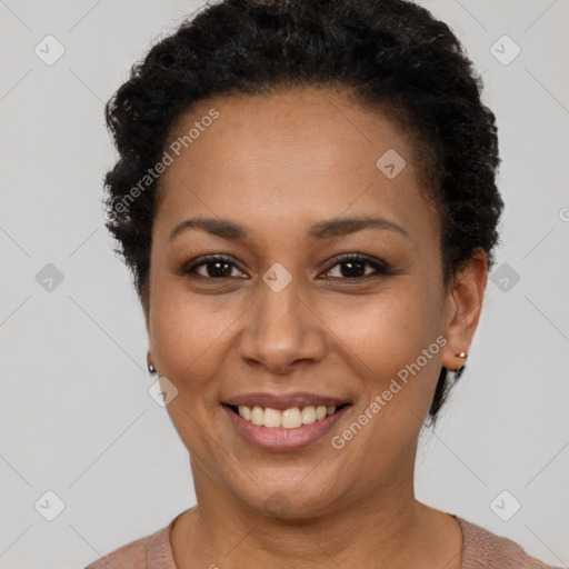 Joyful black adult female with short  brown hair and brown eyes