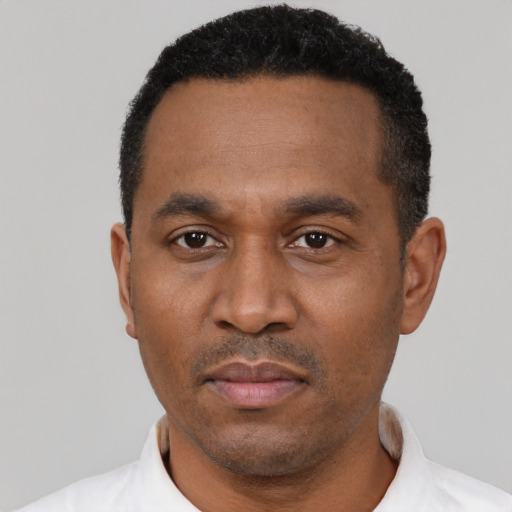 Neutral latino adult male with short  black hair and brown eyes