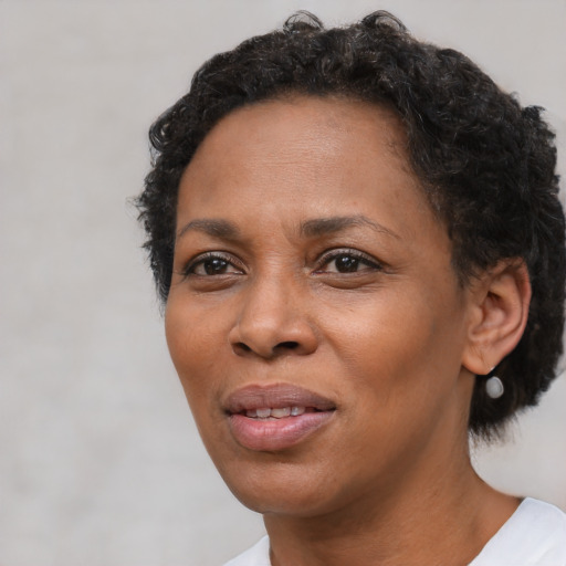 Joyful black adult female with short  brown hair and brown eyes