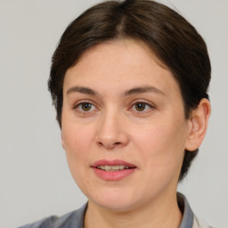 Joyful white adult female with short  brown hair and brown eyes