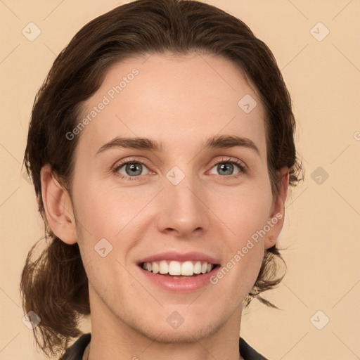 Joyful white young-adult female with medium  brown hair and grey eyes