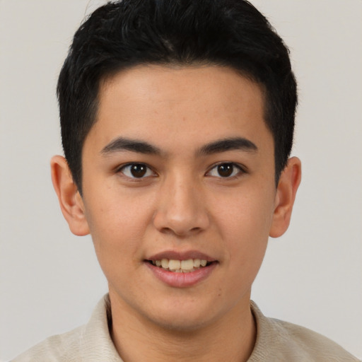 Joyful latino young-adult male with short  brown hair and brown eyes