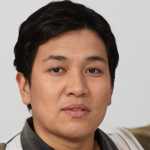 Joyful asian young-adult male with short  brown hair and brown eyes