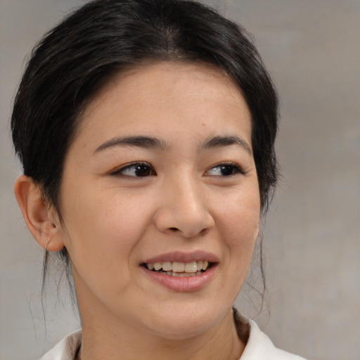 Joyful asian young-adult female with medium  brown hair and brown eyes