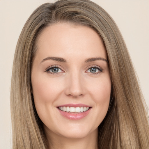 Joyful white young-adult female with long  brown hair and brown eyes