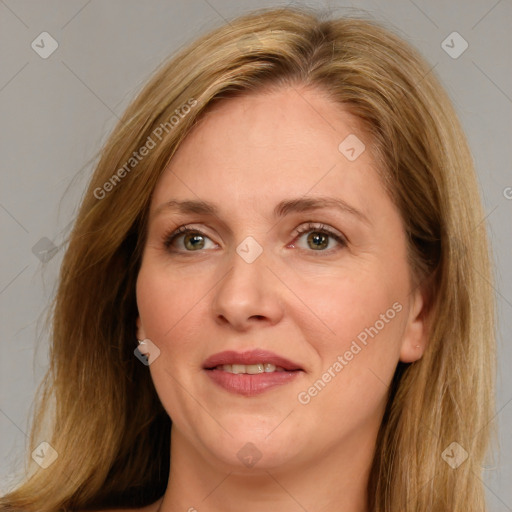 Joyful white adult female with long  brown hair and blue eyes