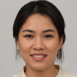 Joyful asian young-adult female with medium  brown hair and brown eyes