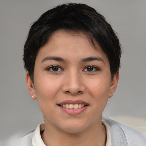 Joyful asian young-adult female with short  brown hair and brown eyes