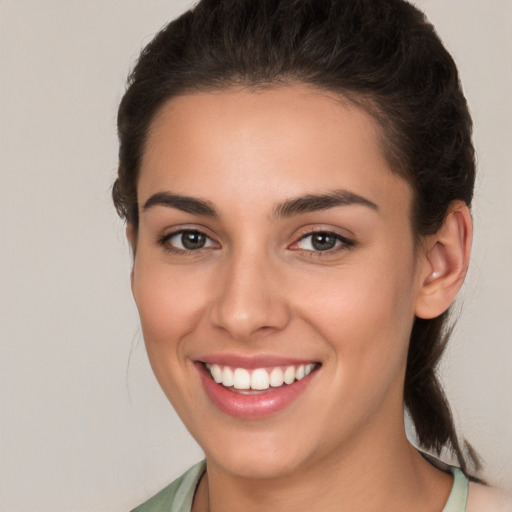 Joyful white young-adult female with medium  brown hair and brown eyes