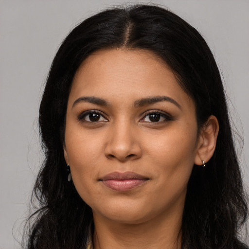 Joyful latino young-adult female with long  black hair and brown eyes