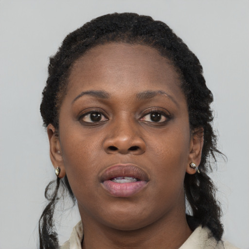 Neutral black young-adult female with long  brown hair and brown eyes
