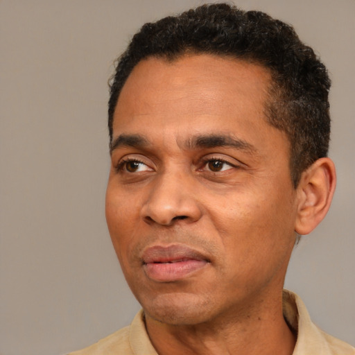 Joyful latino adult male with short  black hair and brown eyes