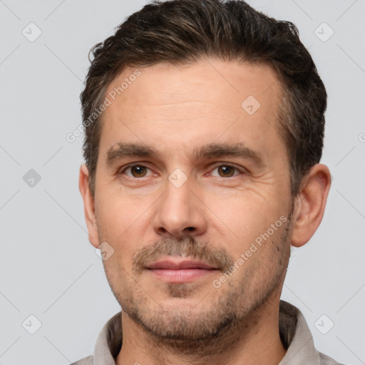 Joyful white adult male with short  brown hair and brown eyes