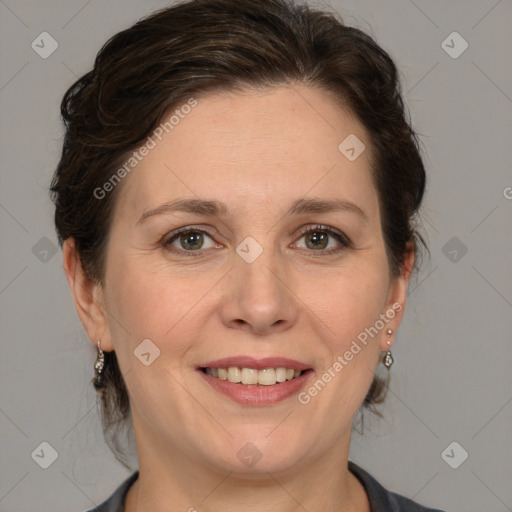 Joyful white adult female with medium  brown hair and grey eyes