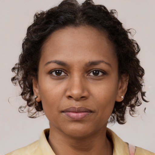 Neutral black young-adult female with medium  brown hair and brown eyes