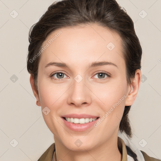 Joyful white young-adult female with medium  brown hair and grey eyes