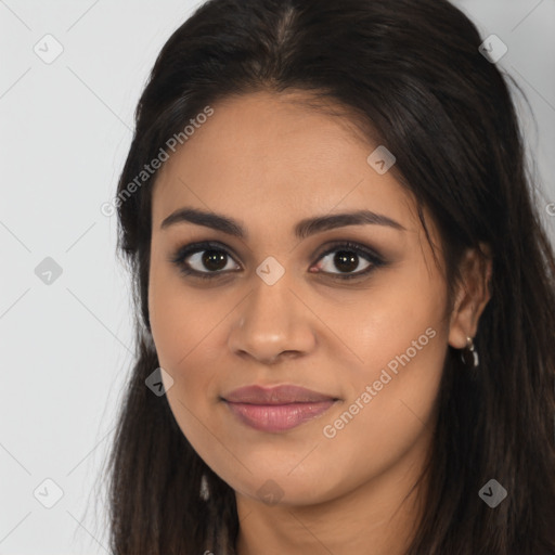 Joyful latino young-adult female with long  brown hair and brown eyes