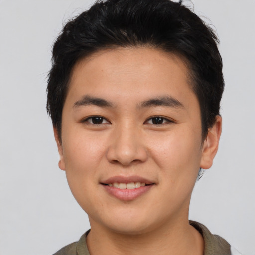 Joyful asian young-adult male with short  brown hair and brown eyes