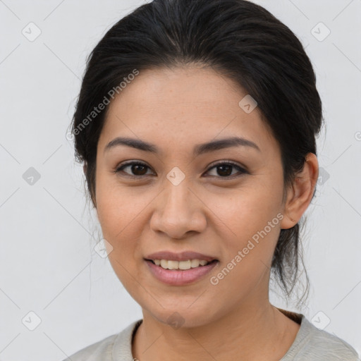 Joyful latino young-adult female with medium  brown hair and brown eyes