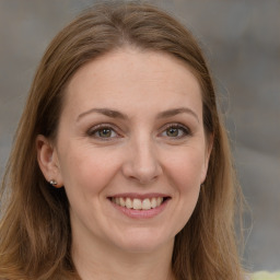 Joyful white adult female with long  brown hair and brown eyes