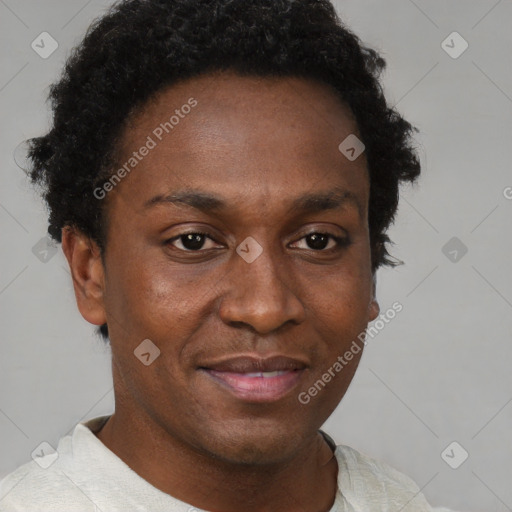 Joyful black young-adult male with short  brown hair and brown eyes