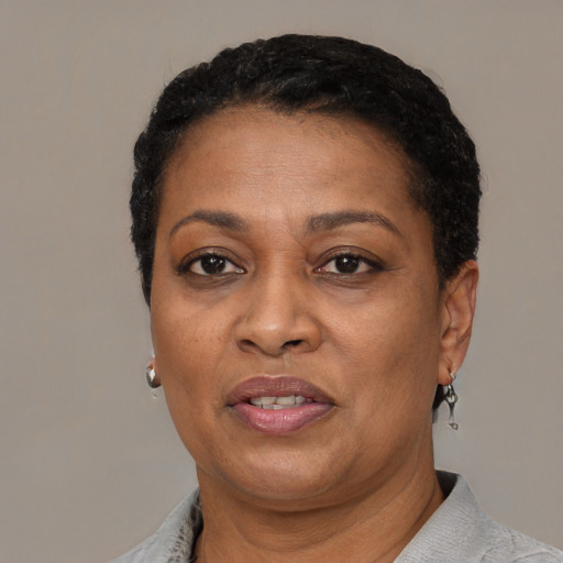 Joyful black adult female with short  brown hair and brown eyes