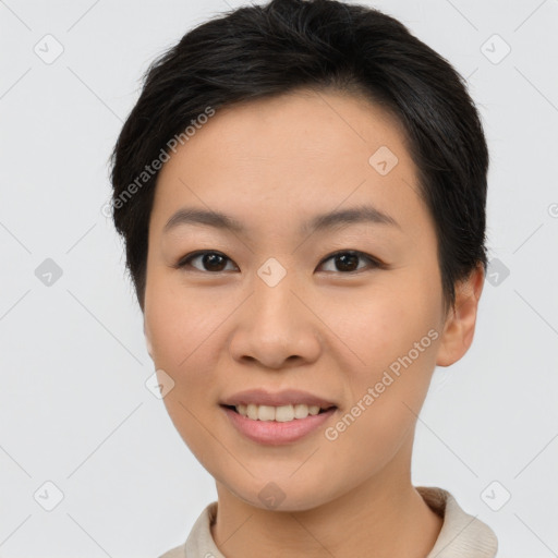 Joyful asian young-adult female with short  brown hair and brown eyes