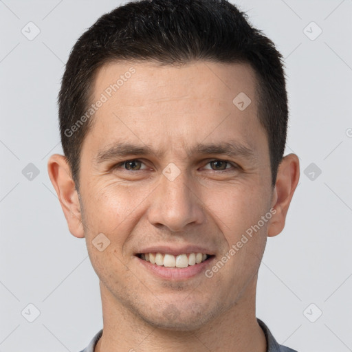 Joyful white young-adult male with short  brown hair and brown eyes