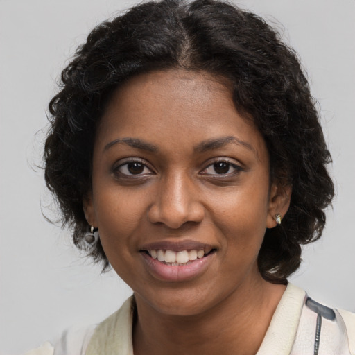 Joyful black young-adult female with medium  brown hair and brown eyes