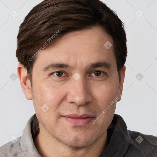 Joyful white adult male with short  brown hair and brown eyes