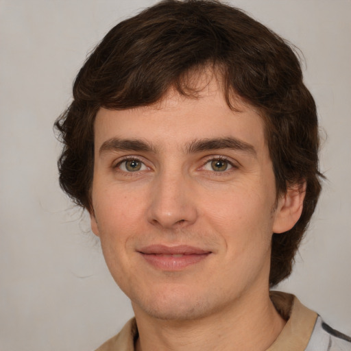 Joyful white young-adult male with medium  brown hair and brown eyes