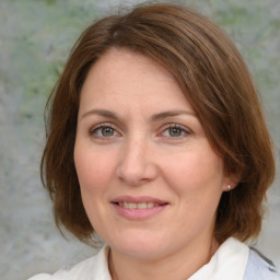 Joyful white adult female with medium  brown hair and brown eyes