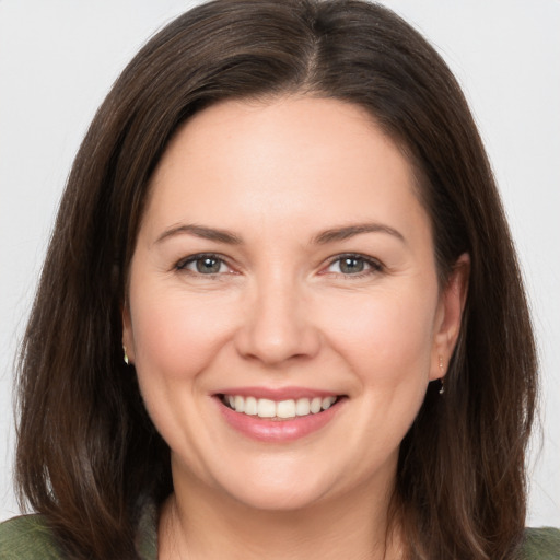 Joyful white young-adult female with medium  brown hair and brown eyes