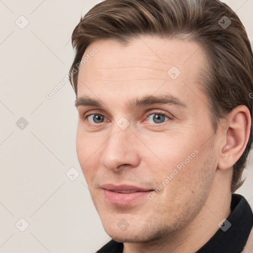 Joyful white young-adult male with short  brown hair and grey eyes