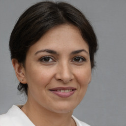 Joyful white adult female with medium  brown hair and brown eyes