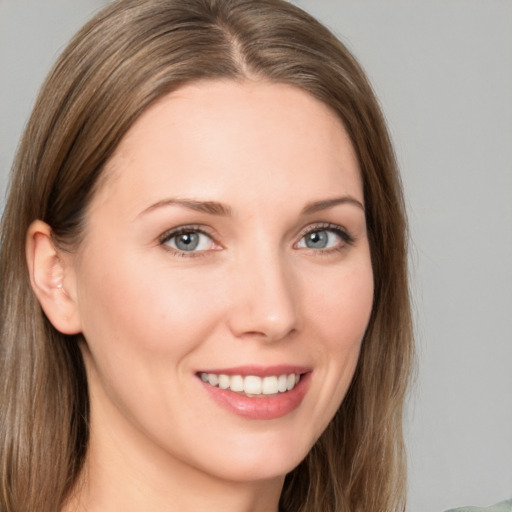 Joyful white young-adult female with long  brown hair and grey eyes