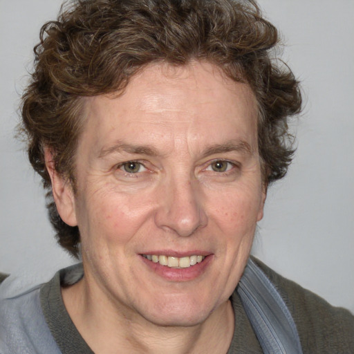 Joyful white adult male with medium  brown hair and blue eyes