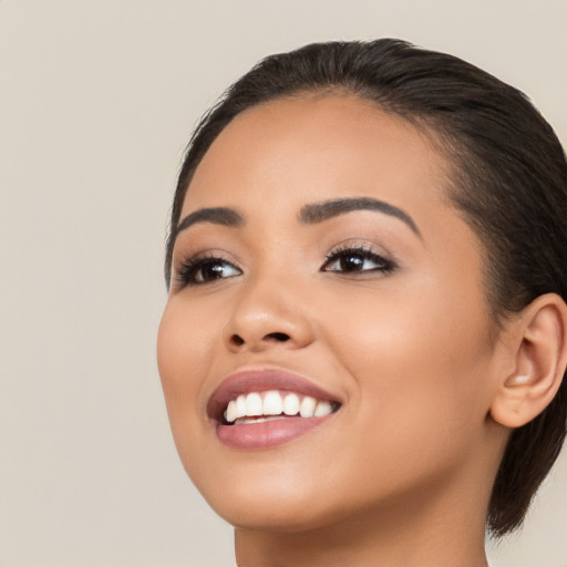 Joyful latino young-adult female with long  brown hair and brown eyes