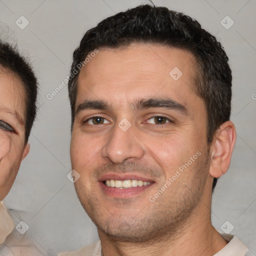 Joyful white young-adult male with short  brown hair and brown eyes