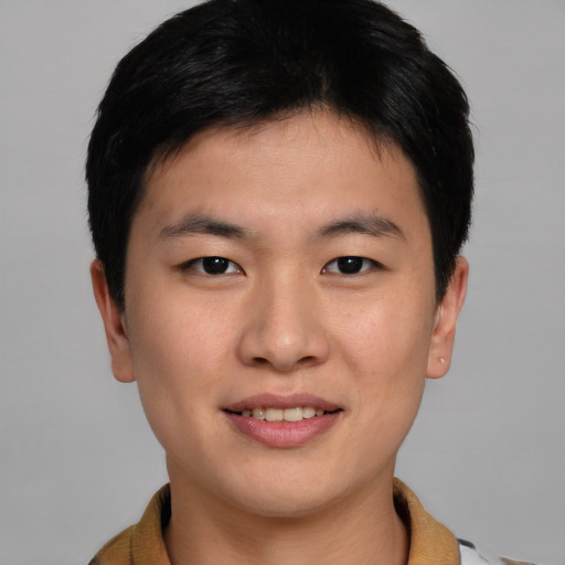 Joyful asian young-adult male with short  brown hair and brown eyes