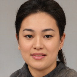 Joyful asian young-adult female with medium  brown hair and brown eyes