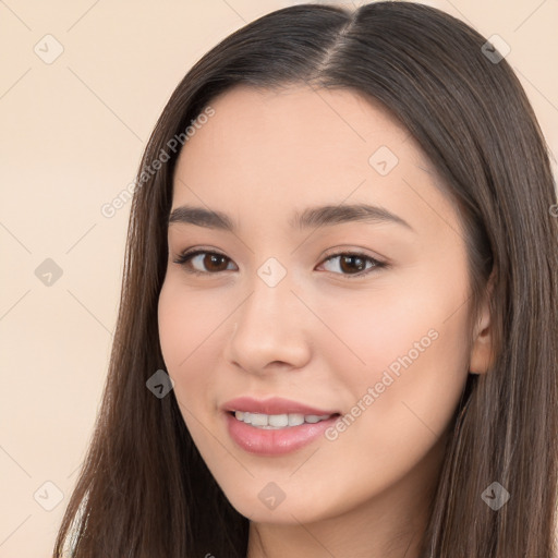 Joyful white young-adult female with long  brown hair and brown eyes