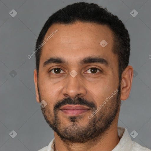 Joyful latino young-adult male with short  black hair and brown eyes