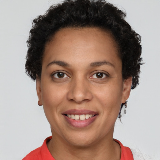Joyful latino young-adult female with short  brown hair and brown eyes
